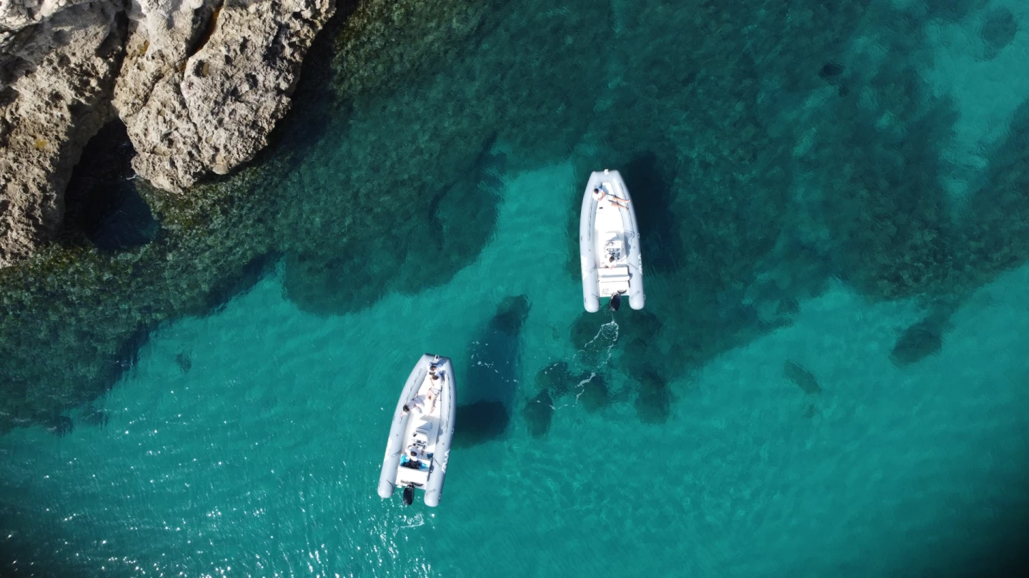 Rent boat Cagliari luxury yacht cruising along the turquoise Sardinia coastline near Poetto Beach