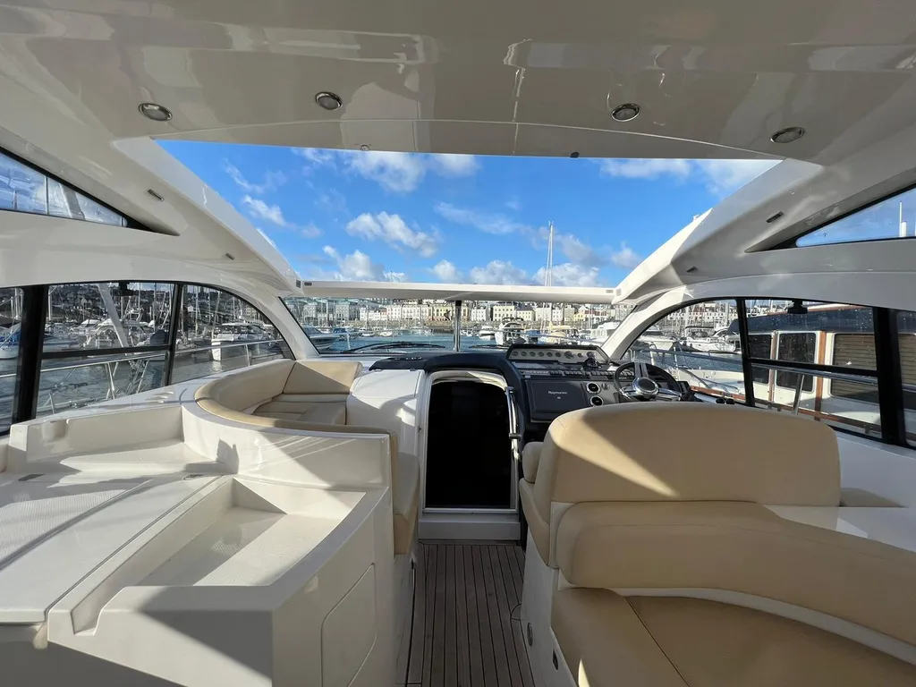 Luxury Fairline Targa 47 GT motor yacht anchored in shallow turquoise lagoon Sardinia