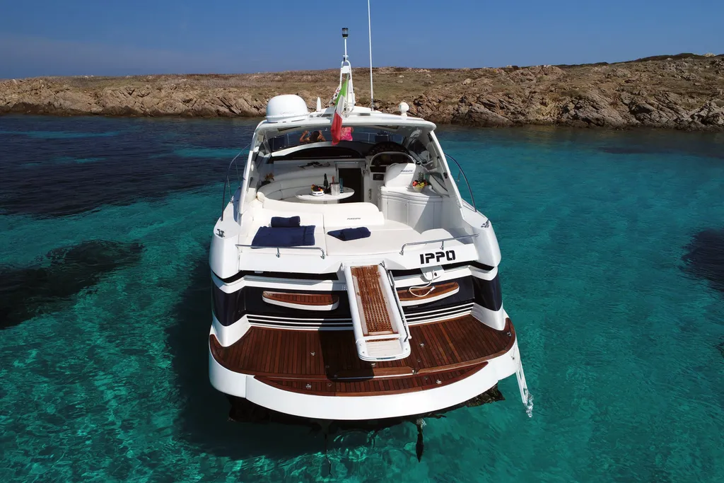 Pershing 43 luxury yacht charter anchored in crystal clear waters Sardinia Italy